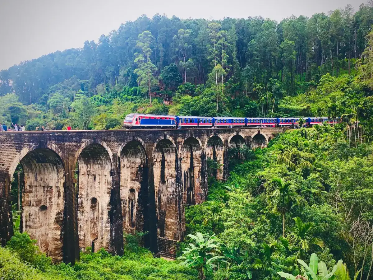 A blue train crossing the Nine Arch Bridge near Ella in the hill country