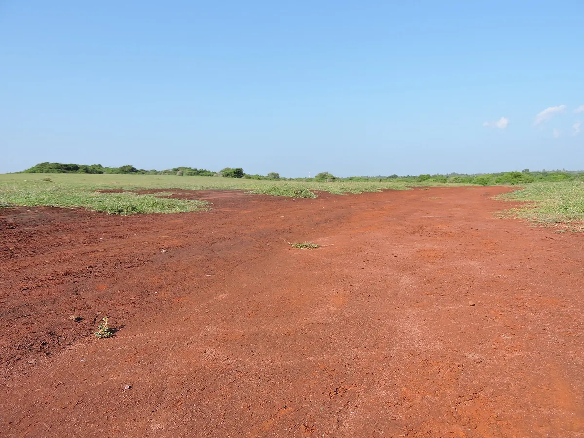 The red soil plateau of Ussangoda National Park under a blue sky